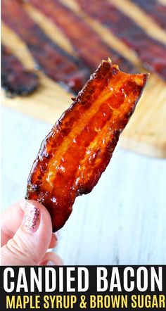 bacon is being held up to the camera with text overlay that reads candied bacon maple syrup and brown sugar