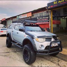 a silver truck parked in front of a building