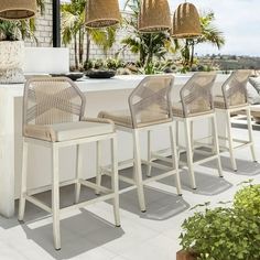 a row of chairs sitting next to an outdoor bar