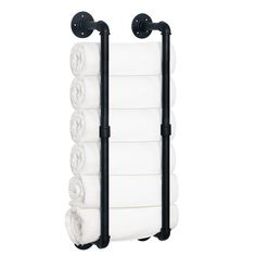 the towel rack has five rolls of white towels hanging from it's black handles