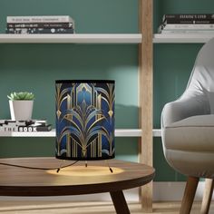 a table with a lamp on it next to a chair and bookshelf in the background