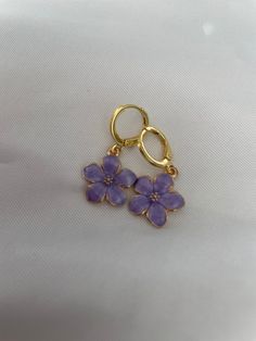 Gorgeous and dainty flower earrings that add a pop to any outfit! These huggie earrings are lightweight and comfortable to wear for long periods of time and are sure to generate compliments! Pretty Earring, Cheap Delicate Flower Earrings, Cheap Dangle Flower Charm Earrings, Trendy Purple Flower Earrings For Gift, Trendy Lavender Earrings For Gift, Trendy Purple Flower Jewelry, Purple Flower Earrings For Spring Gift, Purple Hypoallergenic Flower Drop Earrings, Purple Hypoallergenic Drop Flower Earrings