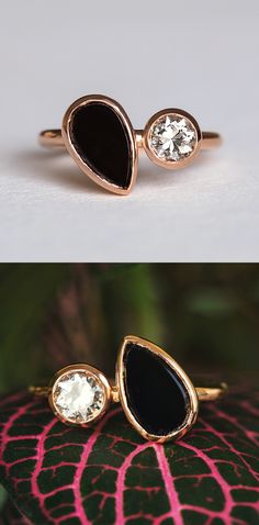 two gold rings with black onyxite and white topazte in the middle