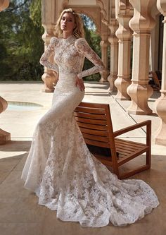 a woman in a wedding dress sitting on a bench