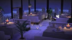 a dining room with tables and chairs overlooking the city at night