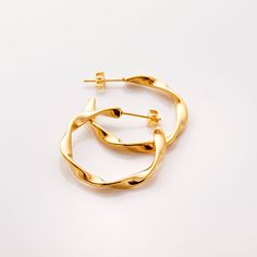 Our Ripple Hoop Earrings are inspired by the ripple effect that a pebble can cause in the ocean - these hoops stand as a reminder that you can have a ripple effect on the world with even the smallest action. Materials & Warranty Material: Real 18 karat gold plating on pure stainless steel Hypoallergenic | Sensitive Skin-Friendly Warranty: Lifetime Warranty against all rust or tarnish Packaging: Nominal Velvet Drawstring Pouch Earrings cannot be returned or exchanged due to hygienic safety The Ripple Effect, Ripple Effect, Drawstring Pouch, In The Ocean, Silver Hoop Earrings, Gold Plating, The Ocean, Sensitive Skin, Women's Earrings