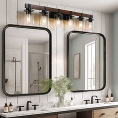 a bathroom with two sinks, mirrors and lights on the wall above them is shown