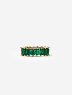 This gold eternity ring with emerald green stones is perfect for adding a pop of colour to your everyday outfits this season.  Wear it alone for a minimalistic look or stack it with our popular eternity ring for an extra sparkle: https://www.etsy.com/uk/listing/874164678/gold-eternity-ring-white-cubic-zirconia 𝗚𝗢𝗢𝗗 𝗧𝗢 𝗞𝗡𝗢𝗪 Forget the fear of tarnishing, skin irritation or green staining; you deserve better than that. We work with only the finest 18 Carat Gold and Sterling Silver which Elegant Green Eternity Band For May Birthstone, Elegant Green May Birthstone Eternity Band, Green Half Eternity Fine Jewelry Band, Green Emerald Round Eternity Band, Green Emerald Eternity Band Round Shape, Green Eternity Band With Prong Setting As Gift, Green Gemstone Eternity Band Fine Jewelry, Green Emerald Eternity Band Fine Jewelry, Green Cubic Zirconia Half Eternity Jewelry