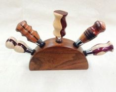 a wooden holder with different types of knives on it's sides and in the middle