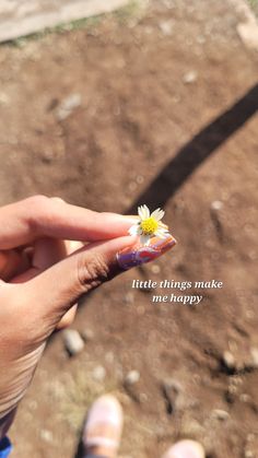 a person holding a tiny flower in their hand with a quote on the side that says little things make me happy