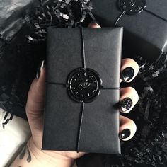 a person holding a black box with nail polish on it and the text wax seals from house & roque visit