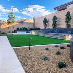 a backyard with artificial grass and landscaping