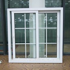 an open window with white frame and glass doors on the outside, in front of a building