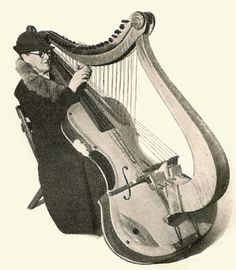 an old photo of a woman playing the harp