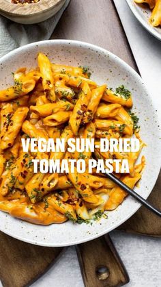 a white bowl filled with pasta on top of a wooden table