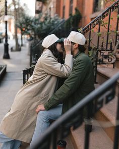 a man and woman are kissing on the steps