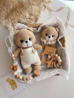 two crocheted teddy bears sitting in a basket next to each other on a table