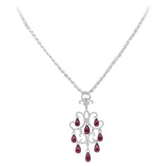 An intricately designed chandelier necklace, featuring pear shape cabochon rubies weighing 16.25 carats total. Accented by round brilliant cut diamonds weighing 0.80 carat total. Finely made with 18K white gold. Pendant is 2.5 inches in length, suspended on a 19 inches white gold chain. Perfect for luxurious events. Available in matching earrings. Please inquire about item DEAR258/2. Chandelier Necklace, Diamond Chandelier, White Gold Chains, Ruby Diamond, Drop Necklace, Brilliant Diamond, Round Brilliant Cut Diamond, Round Brilliant Cut, Brilliant Cut Diamond