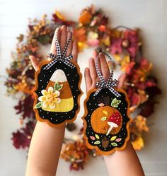 two hands are holding up small handmade tags with the words pattern in front of them