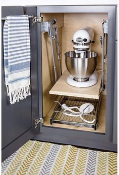 an open cabinet with a mixer and other kitchen accessories