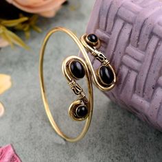 "Natural Black Obsidian Bangle , Gemstone Bangle , Ethnic Cuff Bracelet , Adjustable Bangle , Gold Plated Jewelry ❥ Customers satisfaction is our biggest priority, please contact us with any questions/queries for future or existing orders, and we will do our best to make sure you are happy with your order. ❥Please make sure to add the correct address during check out. You can return your purchased item within 15 days after successful delivery. We offer a 100% \"Money Back Guarantee\" if you are not satisfied with your purchase. Return charges will be paid by buyers only! ❥ Please share your numbers (in personalization box ) as required for shipping address details, and it'll help us to contact you easily. And don't worry about the privacy, we'll keep it safe with us, So try to cooperate wi Bohemian Black Bangle As Gift, Handmade Black Bohemian Bangle, Black Metal Bohemian Cuff Bracelet, Bohemian Black Metal Cuff Bracelet, Bohemian Metal Cuff Bracelet With Natural Stones, Black Bohemian Bangle Jewelry, Bohemian Black Bangle Jewelry, Upper Arm Cuff Bracelet, Gold Arm Cuff