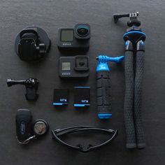 the contents of a gopro camera and accessories laid out on a black table top