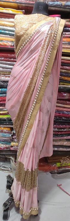 DETAILS COLOR : Pink FABRIC : satin WORK : Heavy Sequin Work, pearl Lace Border OCCASION : Wedding, Reception, Mehendi, Engagement, Party Wear, Festival Blouse READY-TO-WEAR : yes Size: 32 Pink Chinon Pre-draped Saree For Navratri, Pink Art Silk Pre-draped Saree For Reception, Pink Art Silk Saree For Reception, Pink Chinon Pre-draped Saree For Eid, Pink Saree With Dori Work For Reception, Pink Dola Silk Saree For Wedding, Pink Pre-draped Saree With Dori Work For Navratri, Pink Bollywood Saree For Wedding, Pink Semi-stitched Saree For Reception