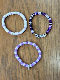 This a great set of 3 purple bracelets for anyone of any age. It's also a great gift for friends or family! Handmade using clay beads. If you want custom colors, please send me a message. Happy to discuss ideas. Adjustable Purple Heishi Beads Bracelets, Purple Friendship Bracelets With Letter Beads, Hypoallergenic Purple Friendship Bracelets, Purple Heishi Beaded Bracelets With Letter Beads, Purple Heishi Beads Bracelet With Letter Beads, Purple Clay Bead Bracelet Ideas, Purple Bracelet Ideas, Purple Clay Bead Bracelet, Trio Bracelets