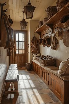 a wooden bench sitting in the middle of a room filled with lots of hanging baskets