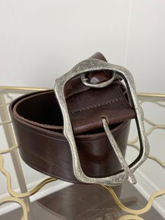 Wide, rugged, brown leather belt with rustic oversized buckle. This is a really great piece. Made in Italy. Label - Million Wishes 40.5" long including buckle 2.25" wide Labelled as a size S/M Largest hole on belt accommodates a 33" waist Smallest hole on belt accommodates a 28" waist Very good vintage condition. Some very minor signs of wear, scuffs/scratches. Please see photos. Sold as presented. I ship from Canada. Shipping is based on weight and volume of belt.  IMPORTANT PLEASE READ  Vintag Hippie Belt, Western Belt Buckles, Belt Vintage, Western Belt, Metal Belt, Western Belts, Brown Leather Belt, Country Western, Suspender Belt