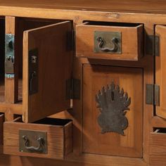 a wooden cabinet with metal handles and drawers