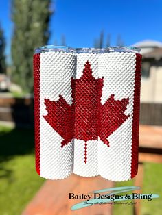 a pair of red and white knitted napkins with a maple leaf on them