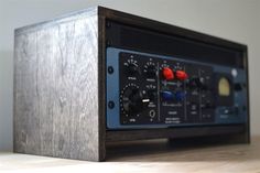 an old fashioned radio sitting on top of a wooden table with buttons and knobs