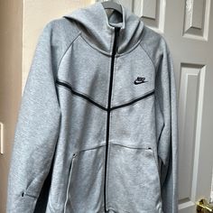 Nike Tech Hoodie New With Tag Techwear Gray Hoodie For Fall, Gray Techwear Hoodie For Fall, Fall Gray Techwear Hoodie, Gray Techwear Hoodie For Outdoor, Nike Heather Grey Long Sleeve Hoodie, Gray Techwear Hoodie For Sports, Gray Functional Streetwear Hoodie, Functional Gray Sweatshirt For Streetwear, Functional Gray Sweatshirt For Winter