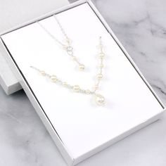 This beautiful bridal necklace is made with Swarovski pearls and sterling silver. Perfect as wedding jewelry for the bride! Shown pearl color is ivory but white and cream colors are also available. Each pearl is carefully hand-wired and connected together one-by-one. The clasp of the necklace is made with small wired pearls. It's perfect for a wedding or a special occasion. Sterling silver Cable chain with spring clasp Swarovski pearls Wire: sterling silver Necklace extender available here: http Elegant Cream Pearl Necklace For Wedding, White Pearl Bridal Accessories With Pearl Drop, White Pearl Drop Bridal Accessories, Cream Pearl Jewelry For Anniversary, Anniversary Pearl Jewelry In Cream, Wedding Bridal Pearl Necklace In Cream, Cream Pearl Necklace With Pendant For Wedding, Cream Pearl Bridal Necklace For Wedding, Cream Pearl Drop Necklace For Wedding