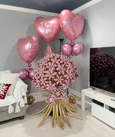 balloons and flowers are arranged in the middle of a living room