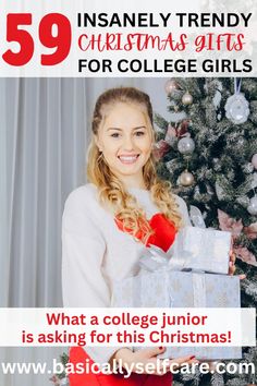 a girl holding a christmas present in front of a christmas tree