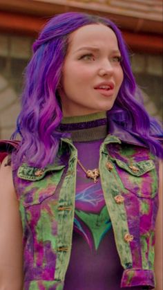 a woman with purple hair wearing a green vest