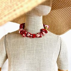 These beads are a two-tone natural Coral in red and white.  The beads are irregular, and the color is best appreciated in person.  The beads are medium size, complimented by two gold color wooden beads.  The necklace makes a statement with its simplicity, showcasing the beauty of the natural cut of the coral.  The natural stone is ideal for daytime, and the shape and design suit nighttime.  The necklace makes it easy to travel with.  The necklace measures 17 inches and weighs 8 ounces. Red Coral Jewelry With Wooden Beads, Red Coral Necklace With Wooden Beads, Red Bohemian Necklace For Beach, Bohemian Red Necklaces For The Beach, Bohemian Red Necklace For Beach, Red Bohemian Shell Necklace For Gift, Red Coral Beaded Necklaces With Wooden Beads, Red Coral Beaded Necklace With Wooden Beads, Adjustable Red Coral Necklace With Large Beads