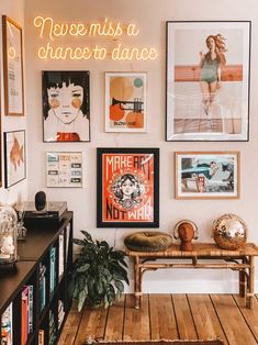 a living room filled with lots of pictures on the wall and a table in front of it