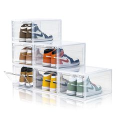 four clear acrylic boxes with different shoes in them on the bottom and bottom