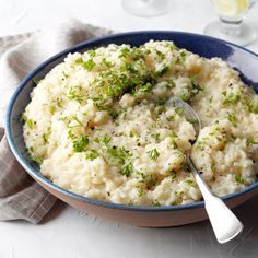 a bowl filled with mashed potatoes and garnished with parsley