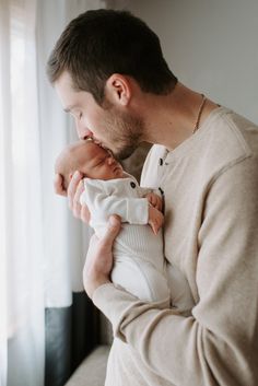 a man holding a baby in his arms