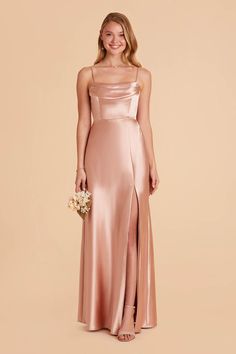 a bridesmaid in a pink satin gown with a slited skirt and side slit