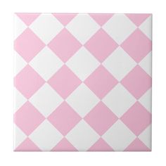 a pink and white checkered tile pattern on the wall, with one square in the center