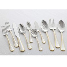 six silver and gold spoons, one with a flower design on the side is shown