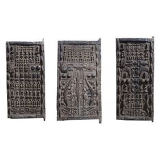 three carved wooden doors are shown against a white background