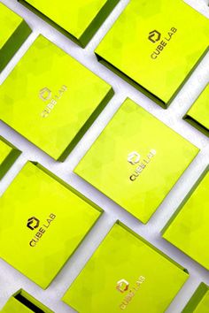 many yellow business cards are arranged in rows