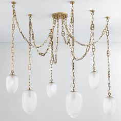 a chandelier with five lights hanging from it's chains and glass globes