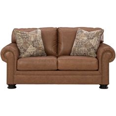 a brown leather couch with two pillows on it's back and one arm facing the camera